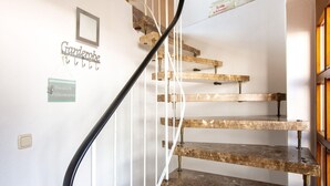 A staircase with a black handrail and wooden steps. There are signs on the wall, one reads "Herzlich Willkommen" and another says "Gardenerobe". - Wohnung in Battenberg nahe Winterberg Skigebiet (Battenberg)