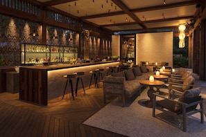 A bar area with wooden furniture and a bar counter.