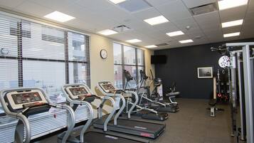 A gym with treadmills, exercise bikes, and weight machines.