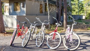 A row of bicycles parked in front of a house with a garage. - Augusta 4 (Bend)