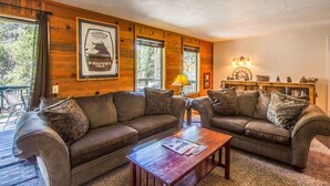 A cozy living room with two sofas, a coffee table, and a lamp. - Coyote 19 (Bend)