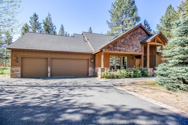 A two-story house with a garage, a covered porch, and a well-maintained driveway. - Duck Pond 3 (Bend)