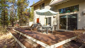 A deck with outdoor furniture and a large umbrella. - Rogue 16 (Bend)