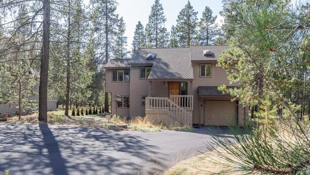 A two-story house with a front porch, a garage, and a driveway. - Rogue 19 (Bend)