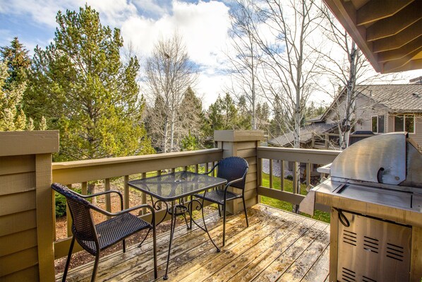 A wooden deck with a grill and two chairs. - Twosome 6 (Bend)