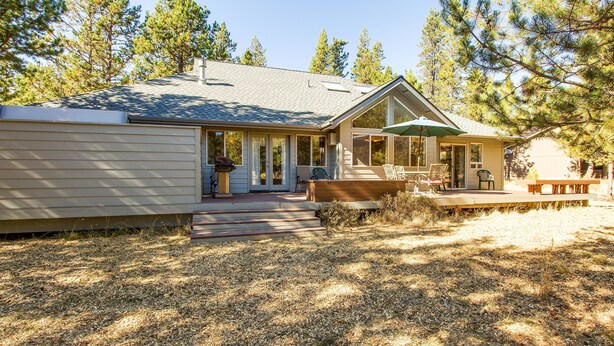 A single-story house with a covered patio, a front porch, and a small deck. - Warbler 12 (Bend)