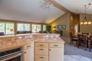 Enjoy meals in a well-lit kitchen with a large island and dining area.