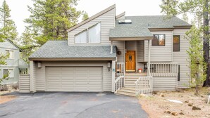 A two-story house with a garage, a front porch with steps, and a small deck. - Red Alder 3 (Bend)