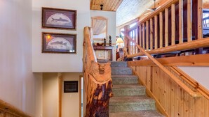 A wooden staircase with a carved handrail leading to a landing. - Tokatee 30 (Bend)