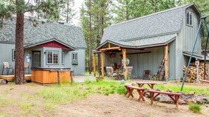A cabin with a porch, a hot tub, and picnic tables. - Indio Road 16997 (Bend)