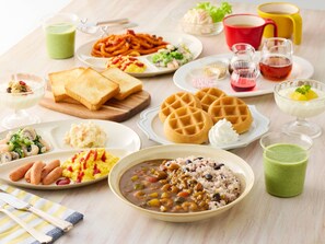 A table with various breakfast dishes including waffles, scrambled eggs, and a bowl of soup. - Comfort Inn Yokaichi (Higashiomi)
