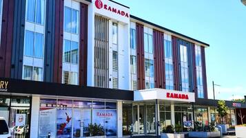 A modern building with the name "RAMADA" prominently displayed.