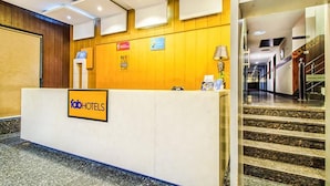 A hotel reception desk with a sign reading "fab hotels".