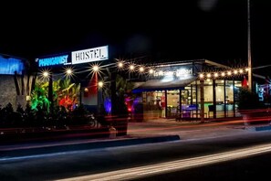 A hostel with a sign reading "HOSTEL" and "PHANGNIST" on the facade.