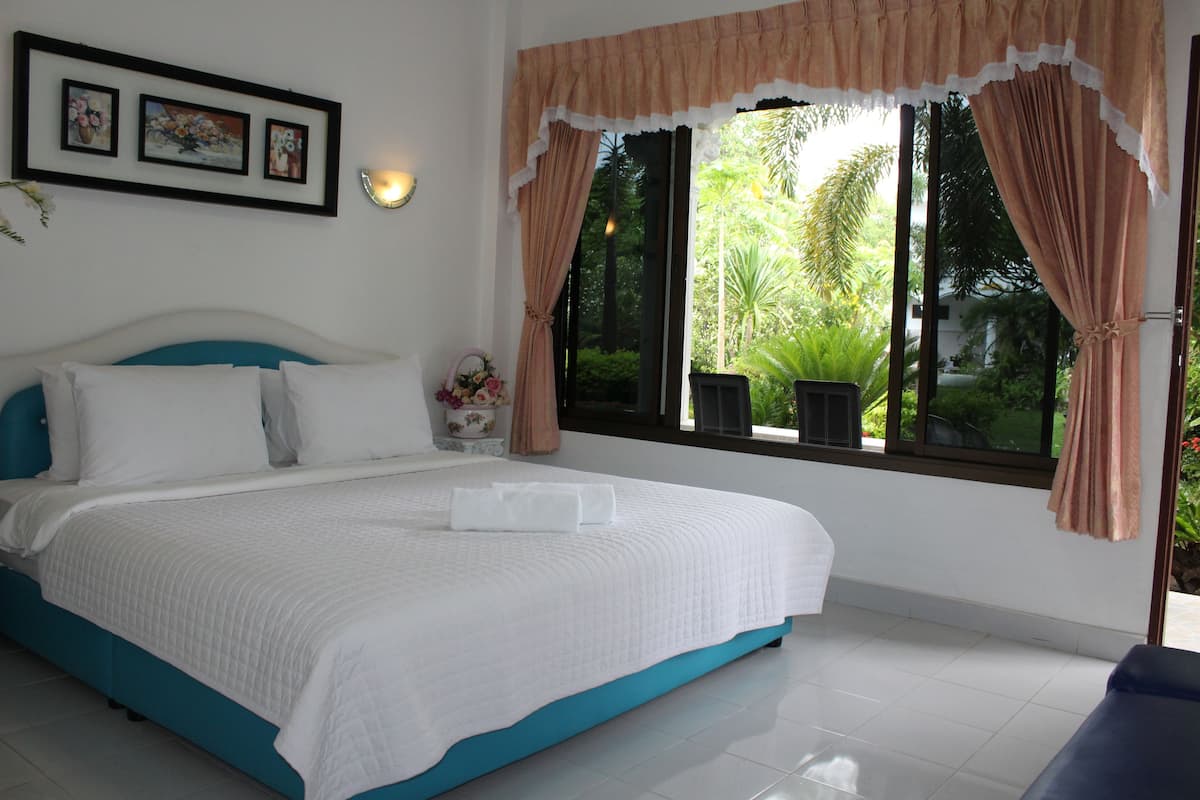 family room, 1 king bed with sofa bed, garden view, garden area | 1 bedroom, premium bedding, free minibar, individually decorated