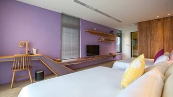 A modern hotel room with a large bed, a desk with a chair, a TV, and a wooden accent wall.