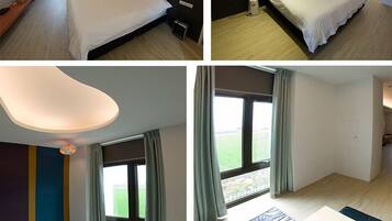 Quarto de hotel com cama, escrivaninha, cadeira e janela com cortinas.