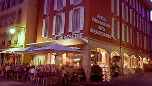 A hotel with outdoor seating and a sign reading "HOTEL BRASSERIE DES NEGOCIANTS". - Hotel Restaurant Les Négociants (Vevey)
