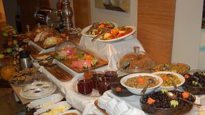 A buffet with various food items and condiments. - Derpa Suite Hotel Osmanbey (Istanbul)