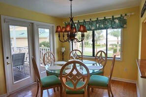 A dining area with a round table, chairs, and a chandelier. - KEN407 5 Bedroom Holiday Home by Marco Naples Vacation Homes (Marco Island)