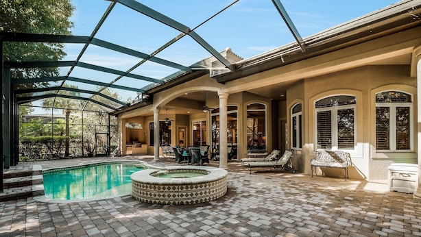 A covered outdoor area with a swimming pool, a hot tub, and seating arrangements. - MAJ8978 4 Bedroom Holiday Home by Marco Naples Vacation Homes (Naples)
