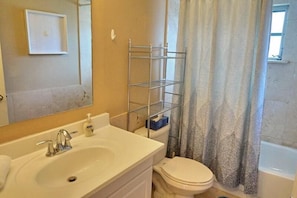 A bathroom with a sink, toilet, and a shower curtain. - NP97TH 730 3 Bedroom Holiday Home by Marco Naples Vacation Homes (Naples)