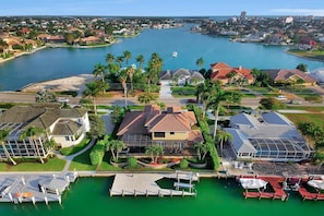 A residential area with houses, a marina, and a large body of water.