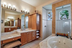 A spacious bathroom with a large bathtub, double vanity with a mirror, and a shower area with a glass door. - SMARCO1255 3 Bedroom Holiday Home by Marco Naples Vacation Homes (Marco Island)