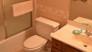 A bathroom with a toilet, a shower, a sink, and a cabinet. - Cove II 233F 2 Bedroom Condo By Midnight Cove II (Siesta Key)