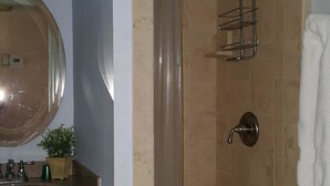 A bathroom with a shower, a sink with a mirror, and a towel rack. - Cove II 510F 2 Bedroom Condo By Midnight Cove II (Siesta Key)