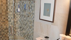 A bathroom with a glass-enclosed shower, a toilet, and a sink with a mirror. - Cove II 732F 2 Bedroom Condo By Midnight Cove II (Siesta Key)