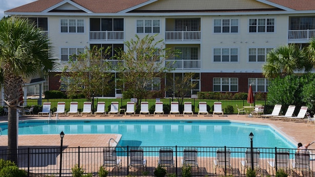 A hotel with a swimming pool, multiple balconies, and outdoor seating areas. - 2314 The Havens (North Myrtle Beach)