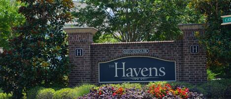 A brick wall with a sign reading "The Havens" and a street sign for "6203 Catalina Dr."