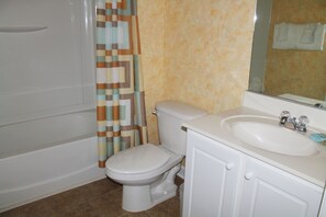 A bathroom with a bathtub, toilet, and sink. - 622 Willow Bend (North Myrtle Beach)
