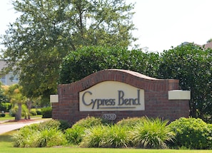 A sign for Cypress Bend with a brick arch and greenery around. - 633 Cypress Bend (North Myrtle Beach)