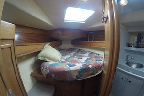 Una cabana petita amb un llit superposat, una cuineta reduïda i un òcul.