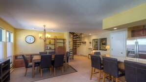 A compact living space with a dining area, kitchen, and a spiral staircase. - Boomerang Lodge 5 2 Bedroom Condo By Accommodations in Telluride (Telluride)