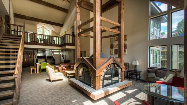 A spacious living area with a fireplace, a staircase, and a glass coffee table. - Boomerang Lodge 5 2 Bedroom Condo By Accommodations in Telluride (Telluride)