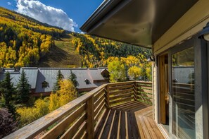 A wooden balcony with a view of a mountain and forest. - Lulu City 3F 2 Bedroom Condo By Accommodations in Telluride (Telluride)