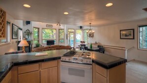 A spacious kitchen with a central island, built-in oven, and ample natural light from large windows. - Madison Pacific 1 Bedroom Condo By Accommodations in Telluride (Telluride)