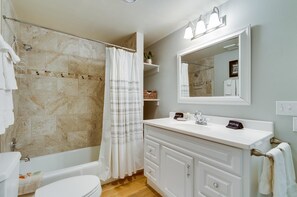 A bathroom with a bathtub, toilet, and vanity with a mirror. - Muscatel Flats 19 1 Bedroom Condo By Accommodations in Telluride (Telluride)