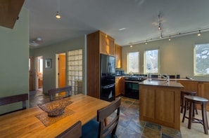 Enjoy meals in the kitchen with a central island, dining area, and large window offering a view.