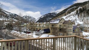 A mountain lodge with multiple buildings, a parking area, and a snowy landscape. - Plunge H 3 Bedroom Condo By Accommodations in Telluride (Telluride)