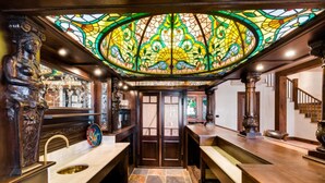 A luxurious bathroom with a large stained glass ceiling, ornate wooden fixtures, and a stone-tiled floor. - Timber Creek 10 Bedroom Holiday home By Accommodations in Telluride (Telluride)