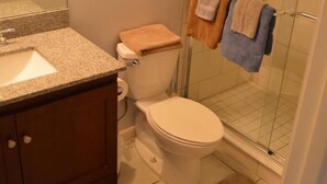 A bathroom with a toilet, sink, and shower. - Cove II 822F 2 Bedroom Condo By Midnight Cove II (Siesta Key)