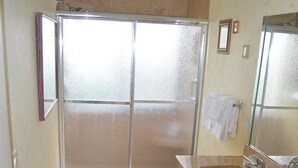 A bathroom with a shower, a sink, and a mirror. - Cove II 912C 2 Bedroom Condo By Midnight Cove II (Siesta Key)