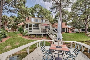 A two-story house with a deck, outdoor seating, and a small garden. - 221 Audubon 3 Bedroom Holiday Home By Coastal Dreamin (Miramar Beach)
