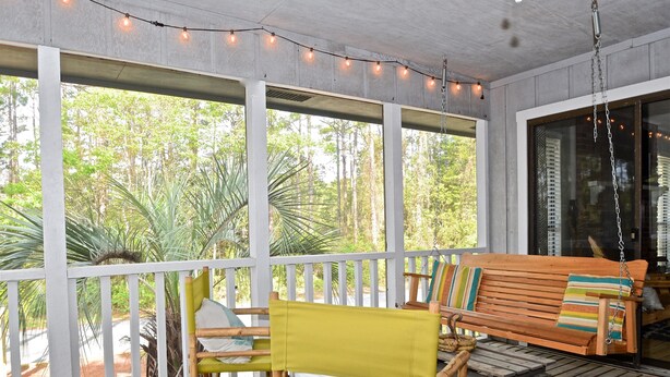 A covered porch with a wooden bench, a yellow chair, and a table. - Grayton Beach Grayt Escape 2 Bedroom Holiday Home By Coastal Dreamin (Santa Rosa Beach)