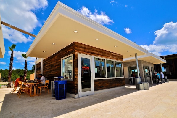 A modern building with a wooden facade, large glass windows, and a flat roof.