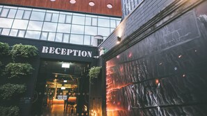 A building with a reception area, large windows, and a modern design. - Bullitt Hotel (Belfast)